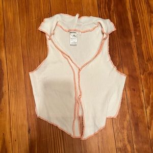 White top with orange stitching